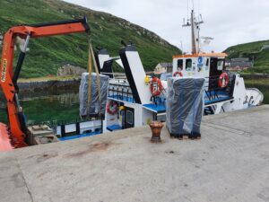 Pallets of Irish Coastal Gin being loaded on Cape Clear Island for Free Distribution Spirits, France.